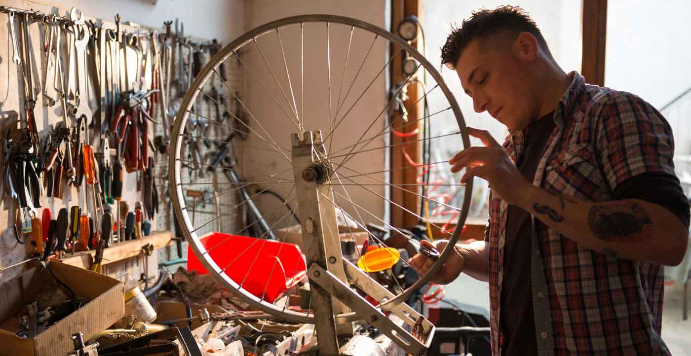 young man working in a bicycle shop
