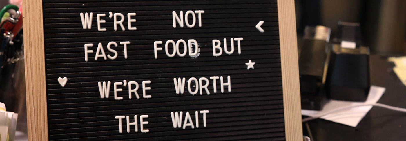 We're Not Fast Food But We're Worth the Wait sign