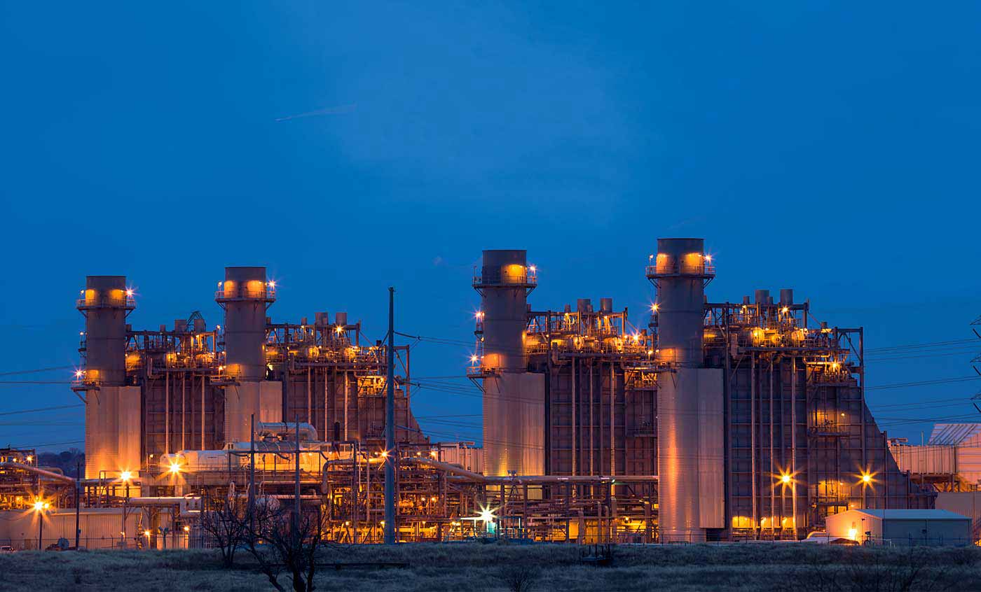 industrial facility lit up at twilight