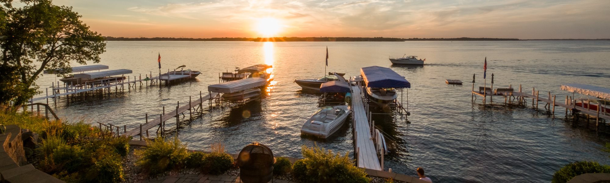 Lakeside view of docks and boats during sunset