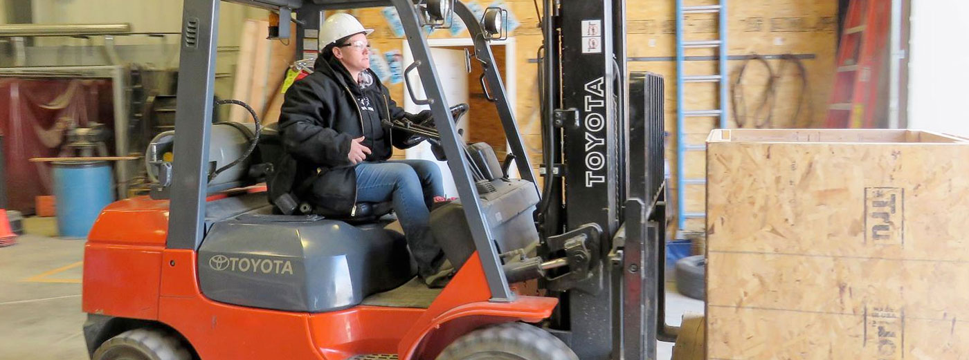 woman operating forklift