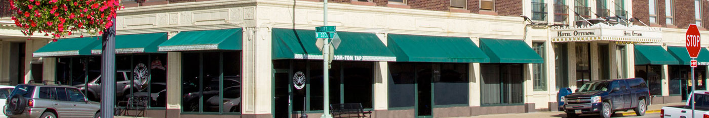 corner storefront with green awnings