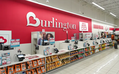 The image shows the checkout counters and signature red wall branding inside a Burlington retail store.