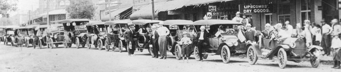 historical photo of cars lining the street