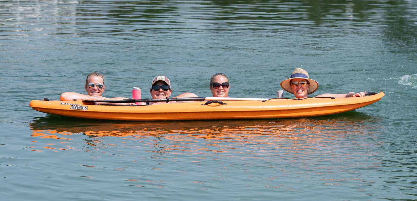 happy people posing with canoe