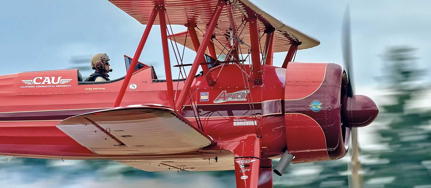 red biplane in flight