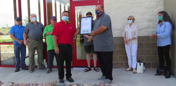 Click the Discount Tire Receives Welcome Plaque Slide Photo to Open