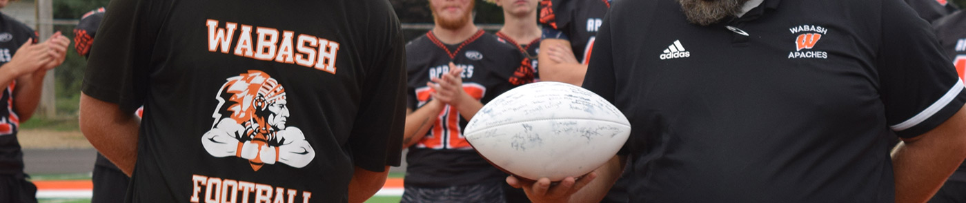 Wabash football players holding signed football