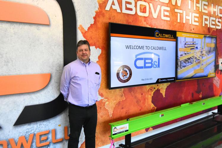 Caldwell Group owner Doug Stitt shows off the new lobby of the company’s Beloit headquarters. Alex Gary/Beloit Daily News