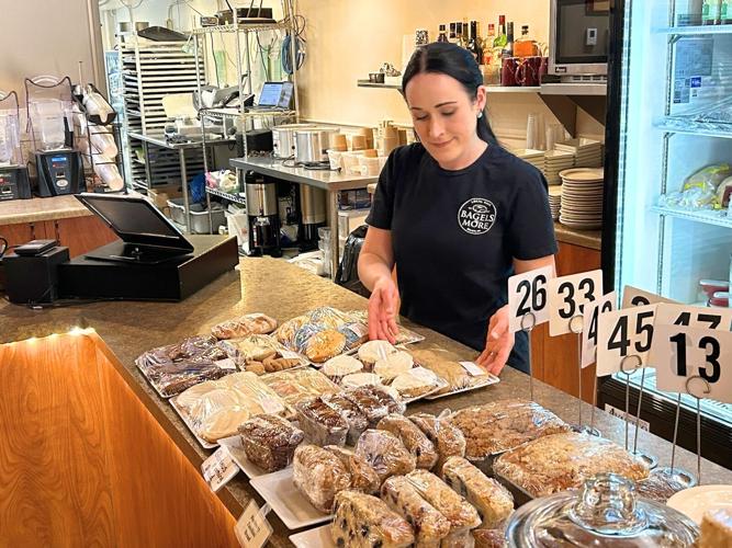 Kelly Rees of Bagels & More arranges fresh baked goods on the counter on Wednesday. Bagels & More is one of the downtown retailers that get a major boost from the Beloit Farmers Market traffic. The market opens for the season on Saturday. Alex Gary/Beloit Daily News