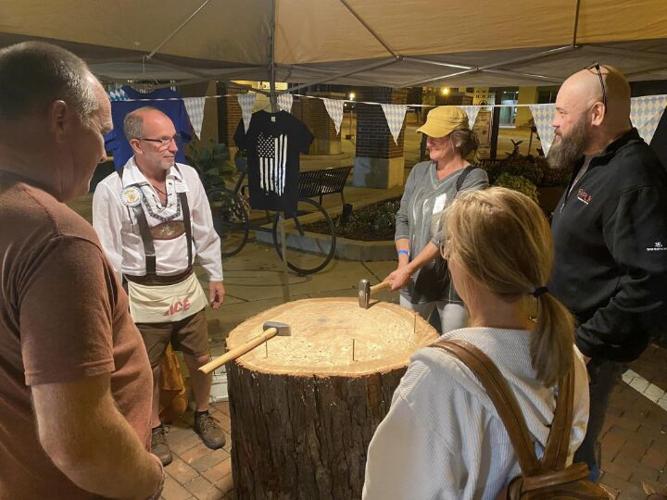 A group of event goers gather around to play hammerschlagen at the Downtown Beloit Association’s Oktoberfest in 2022. This year the event will be held Saturday on State Street in downtown Beloit.
