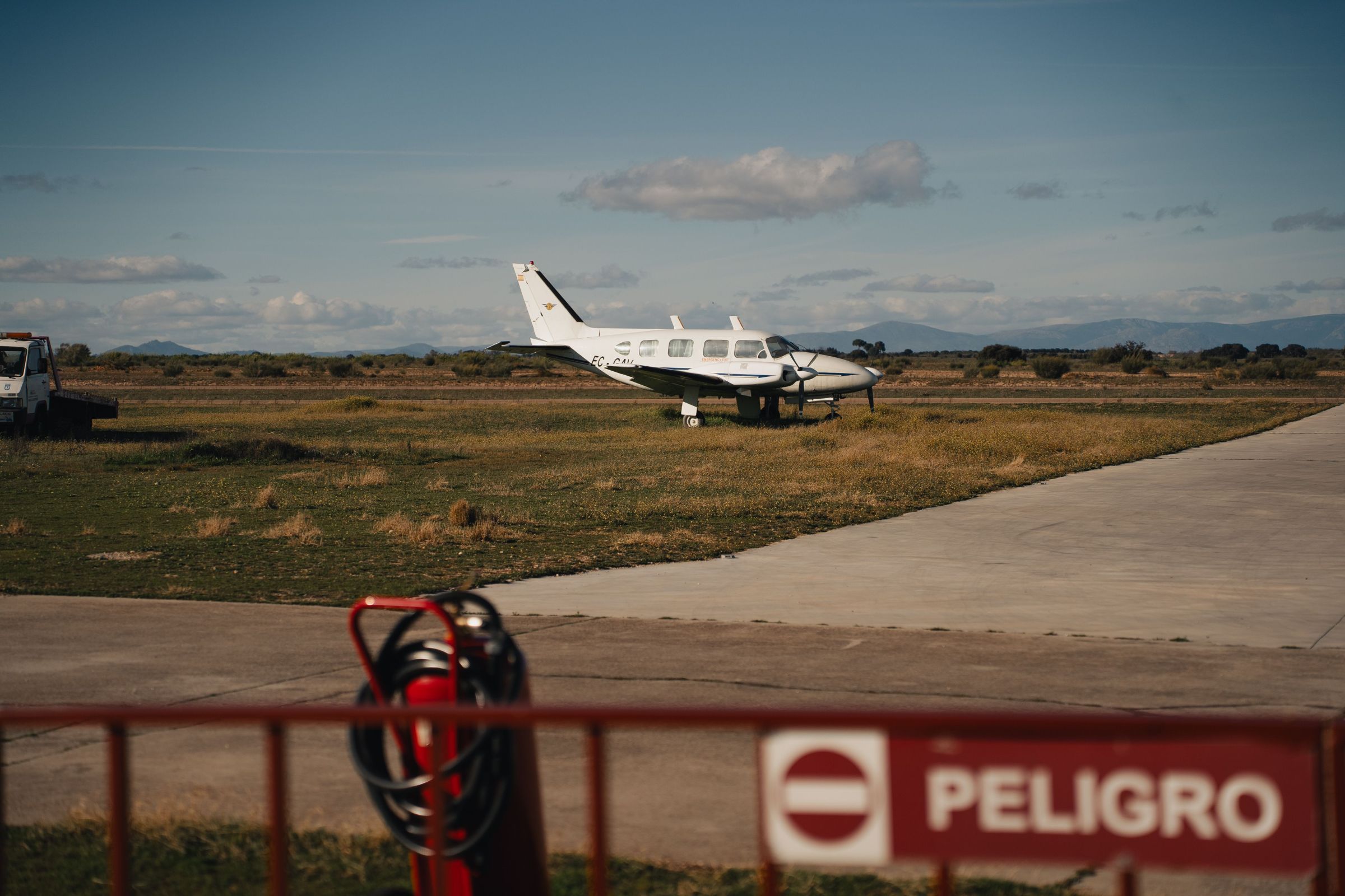 An airplane on a rural runway.