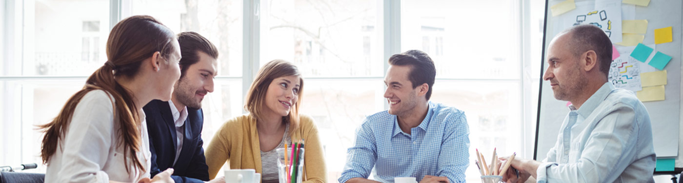 co-workers meeting around an office table