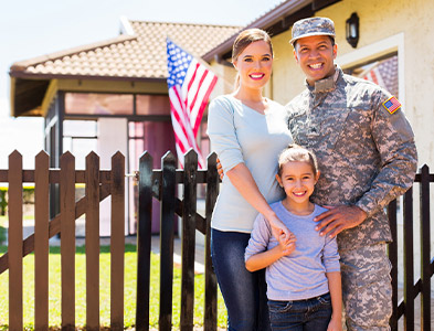 Proud military family in front of their home