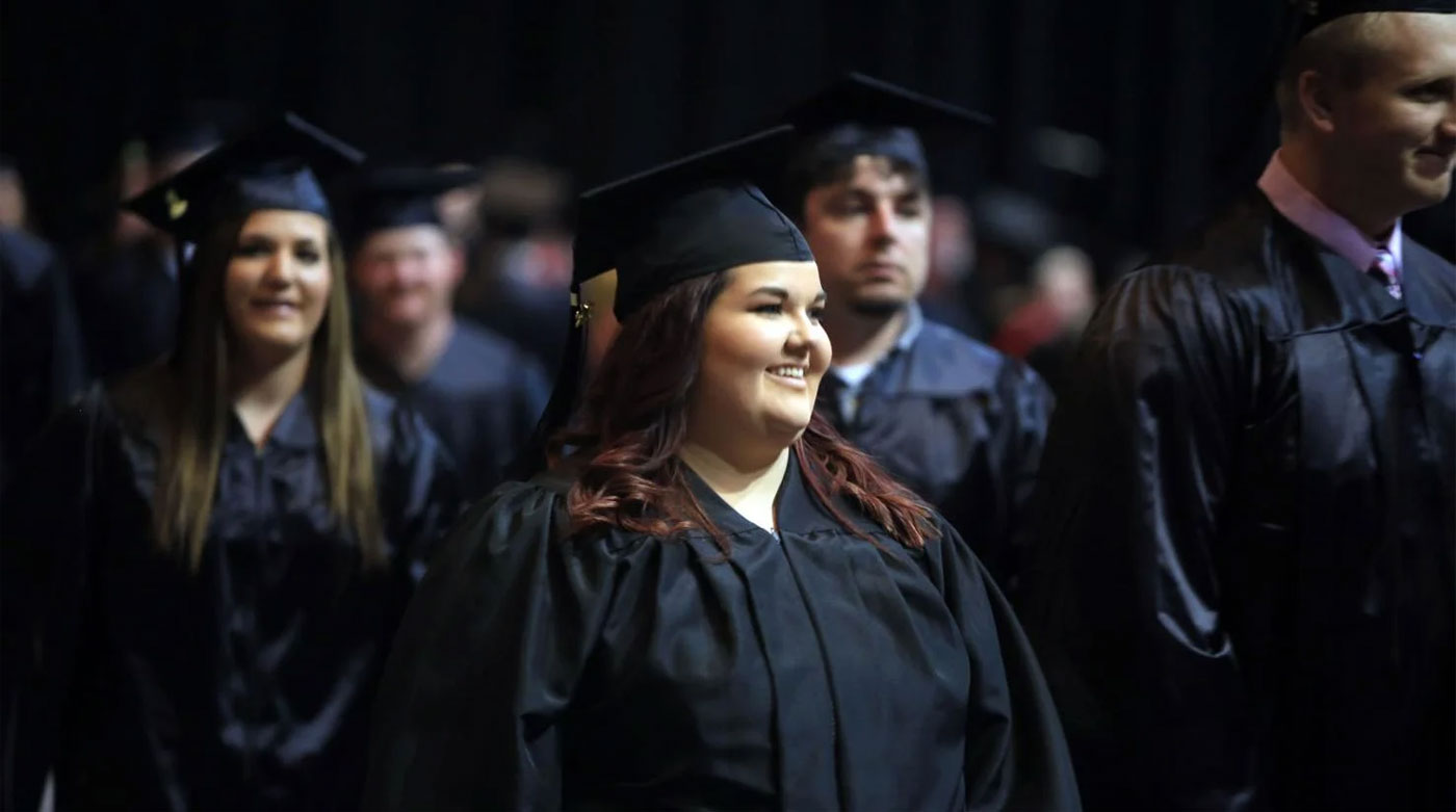 group of young smiling graduates