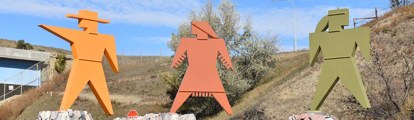 three outdoor roadside human figure metal statutes