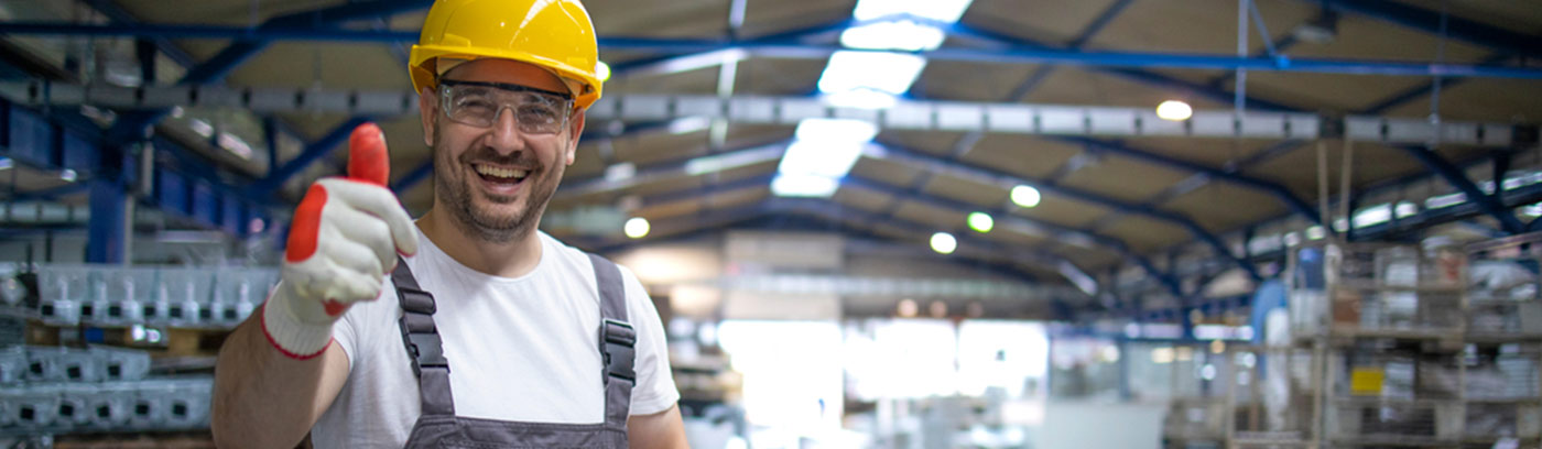 smiling factory work in protective gear