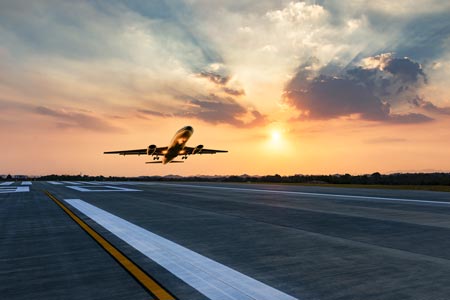 jet taking off at sunset