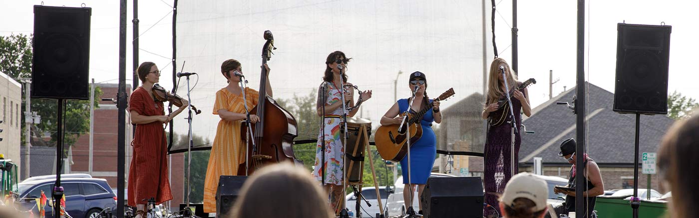 four women playing music on a stage