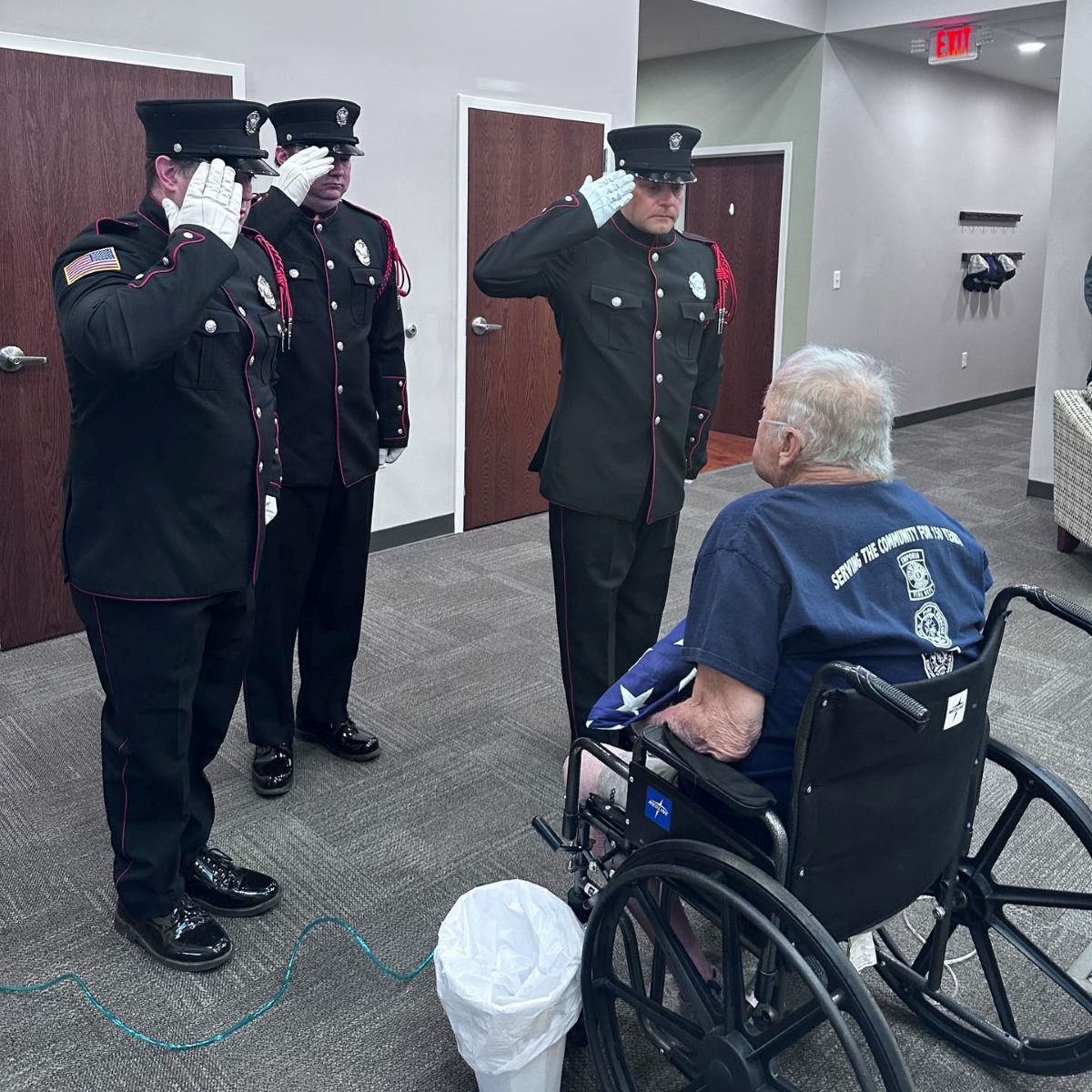 Service members honoring a veteran's service