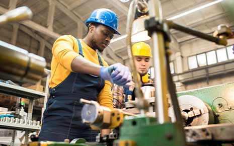 two factory technicians working on equipment