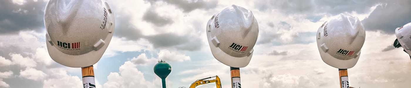 hard hats balancing on golden shovels