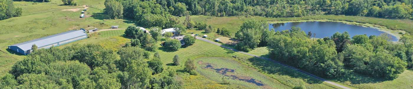 aerial view of farm and pond