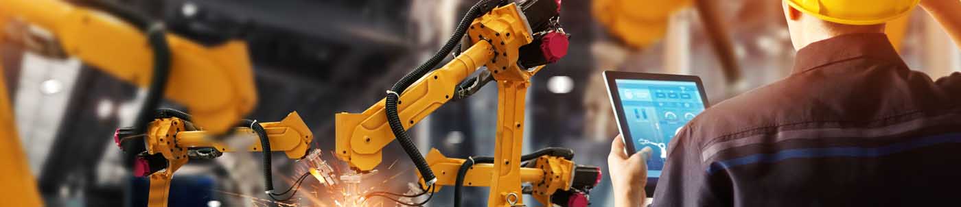man operating manufacturing robot