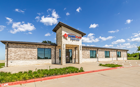 The image shows a location of CureFast Urgent Care, a medical clinic that provides same-day care for minor injuries, illnesses, X-rays, lab testing, and physicals.