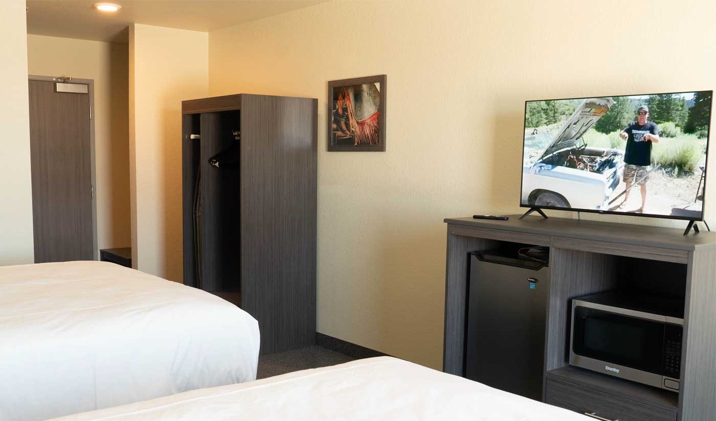 interior of hotel room showing amenities of tv, mini fridge