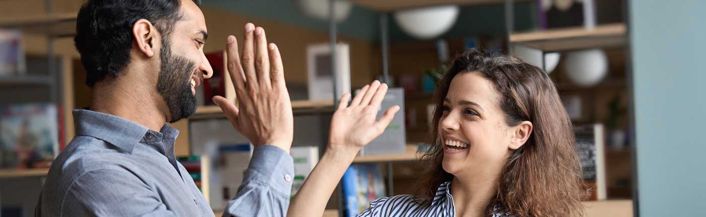 happy co-workers high-fiving each other