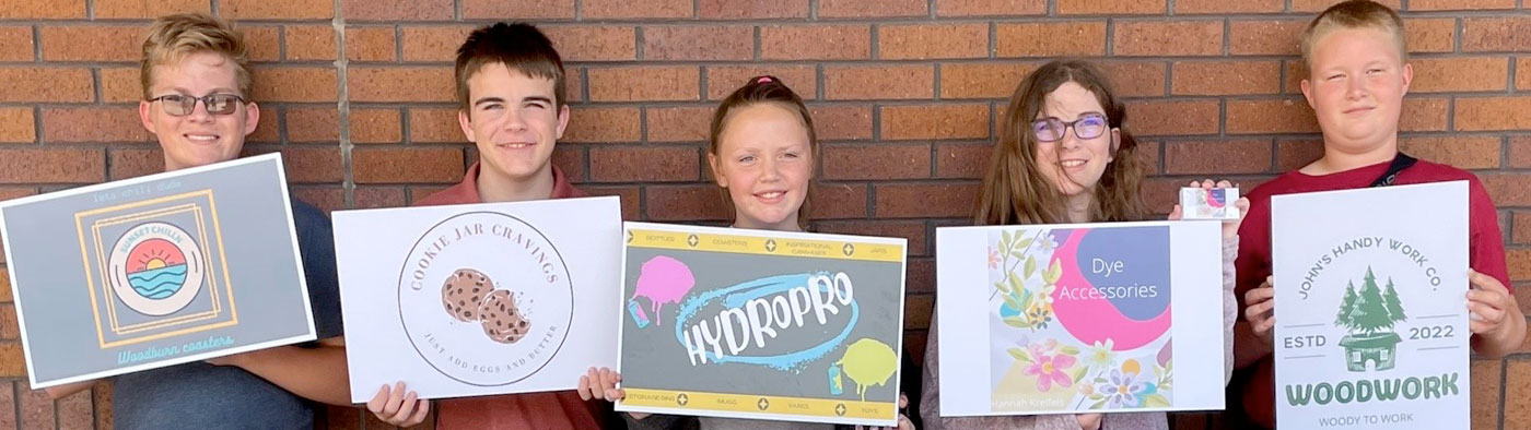 children holding up business signs