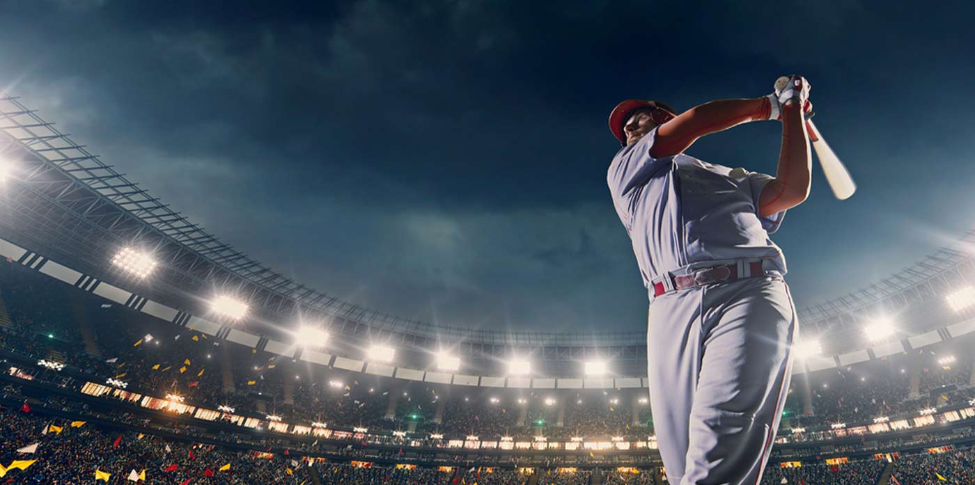 baseball game and player hitting the ball