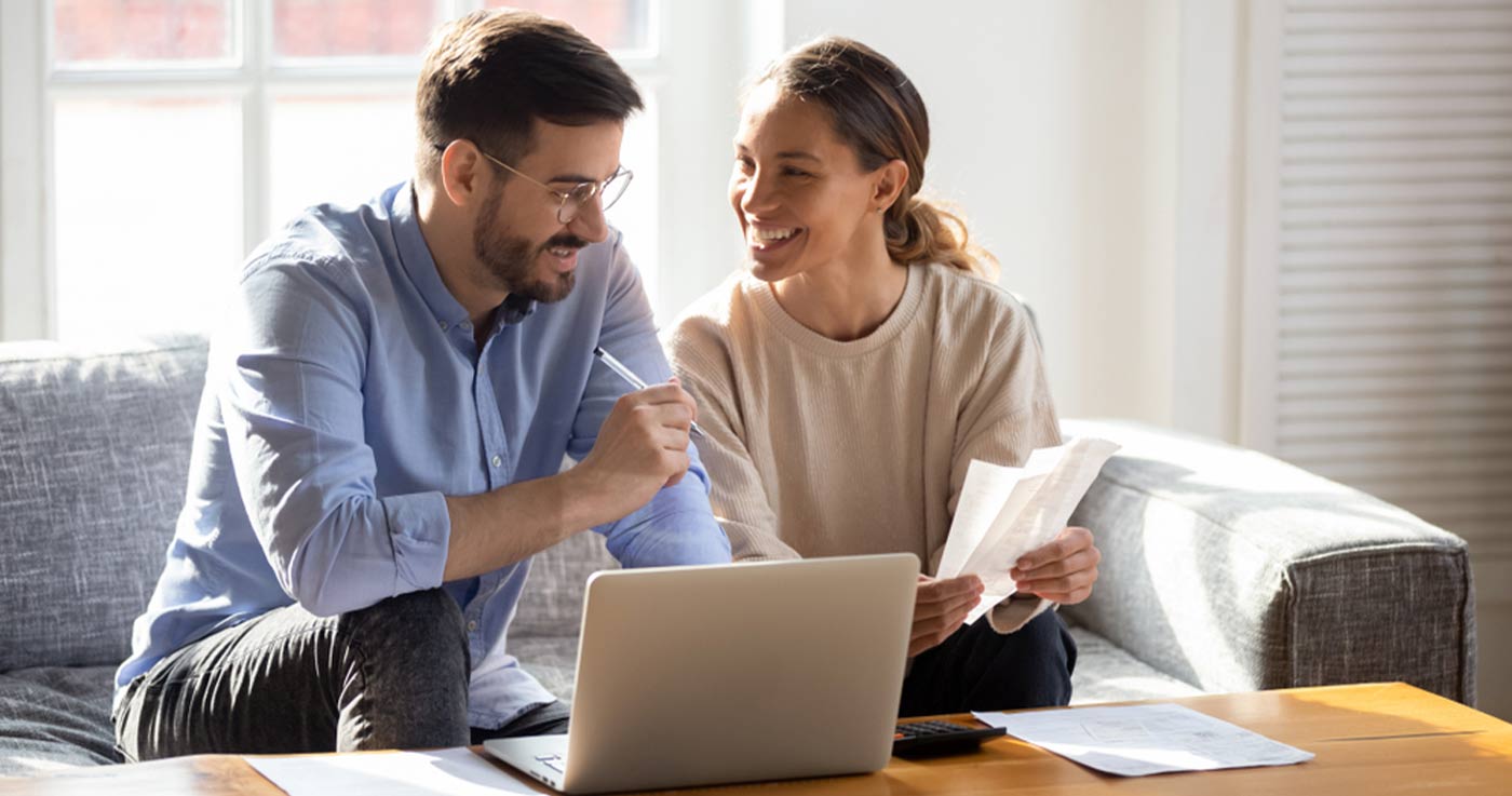 happy couple discussing bills