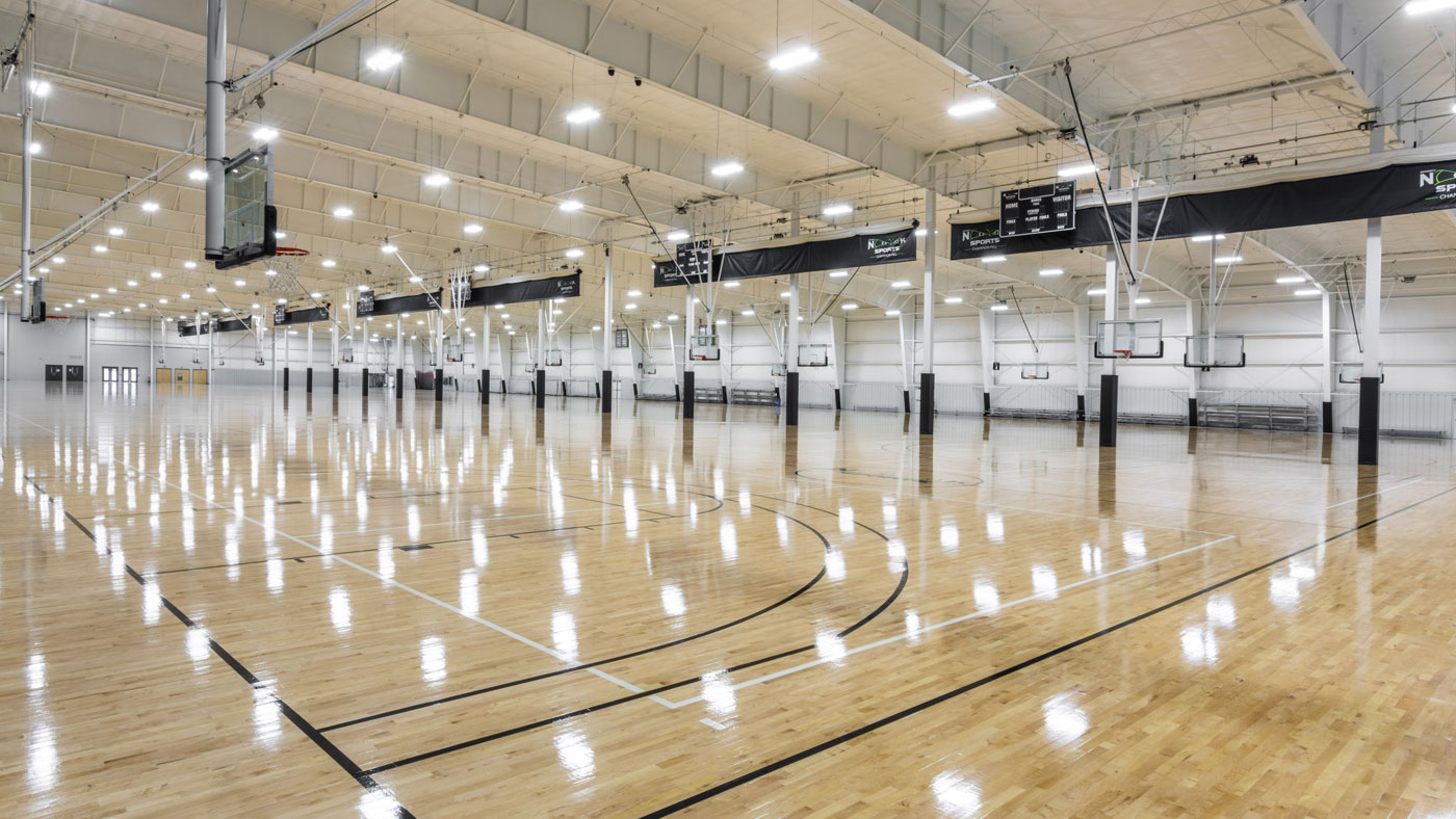 person walking in from of retail district buildings