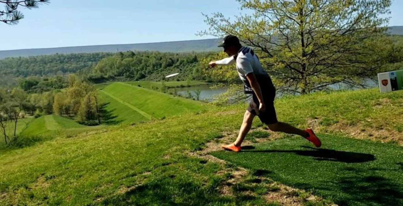 man throwing disc at Faylor Lake Disc Golf Course