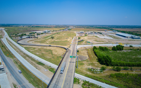 The image shows an aerial view of an overpass and highway interchange.
