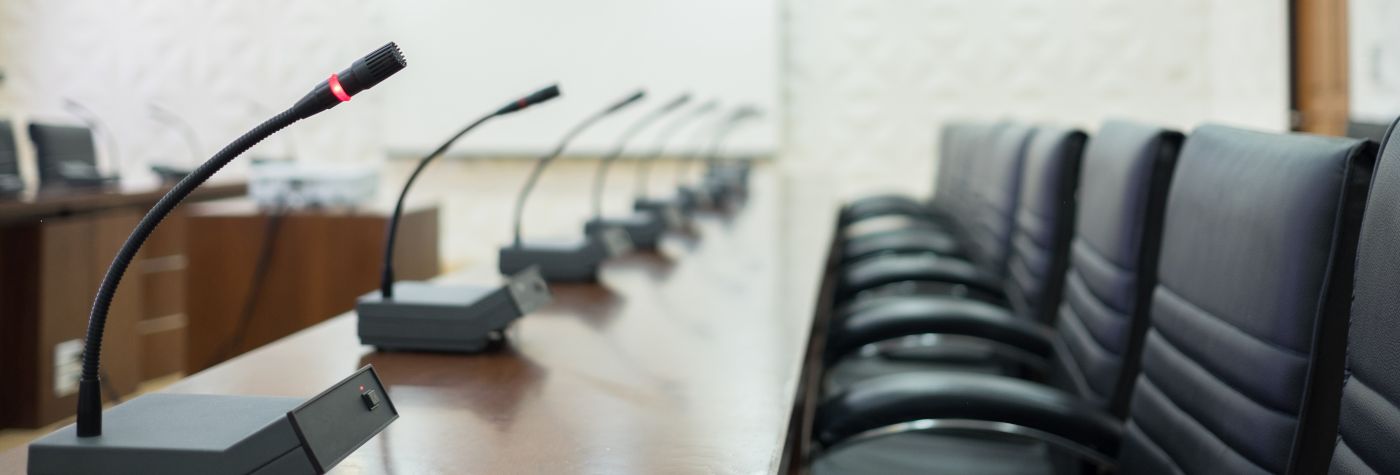 empty conference room with microphones and chairs