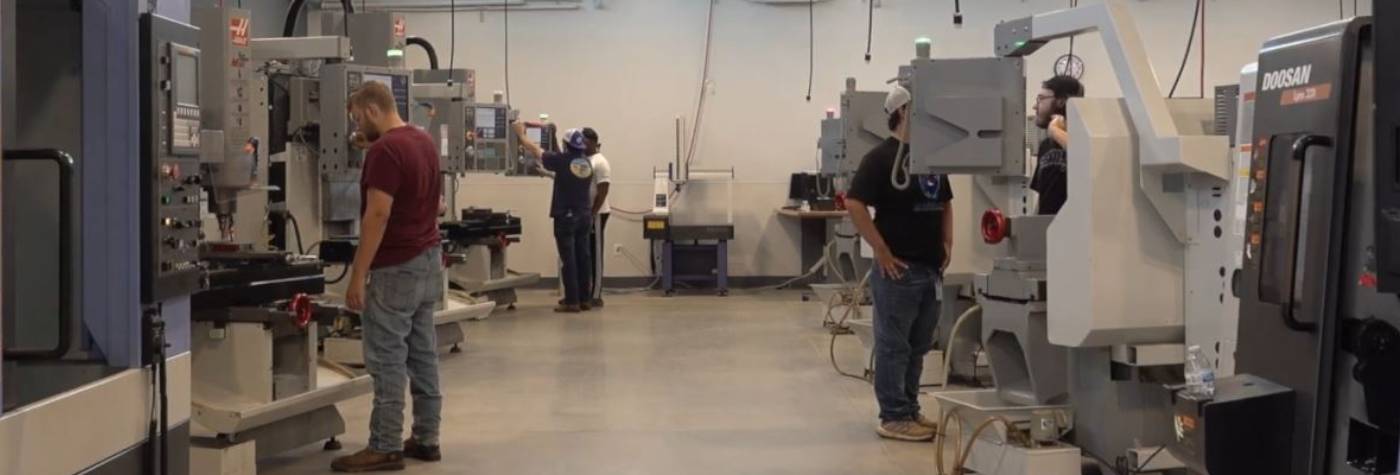 technical students learning about manufacturing machinery