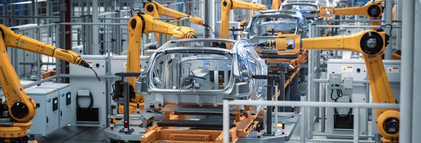 manufacturing factory line of robots building cars