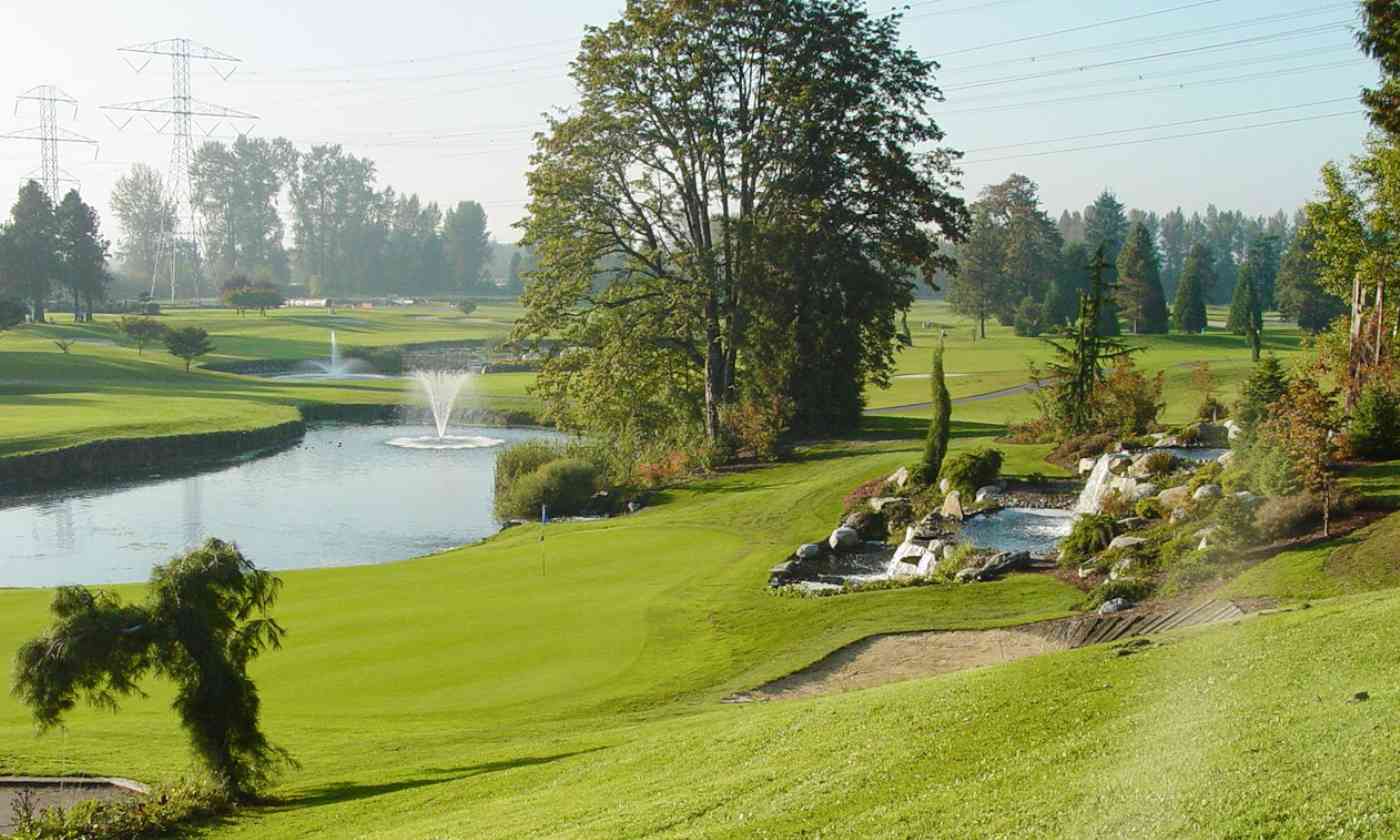 golf course with greenery and lake