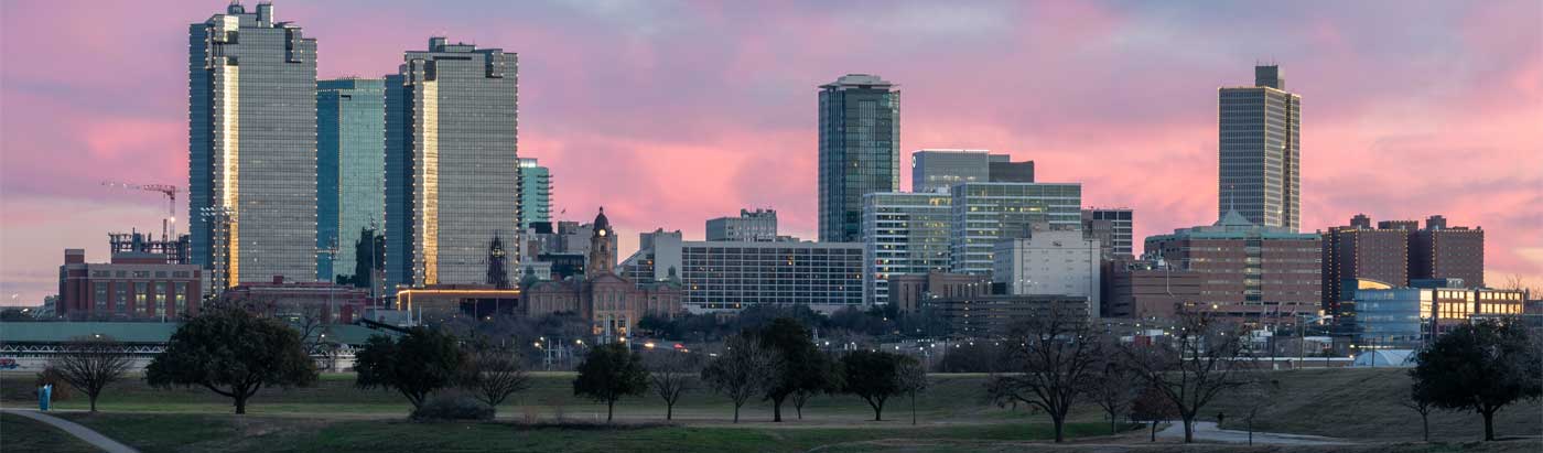 Fort Worth skyline against a beautiful sunset-lit sky