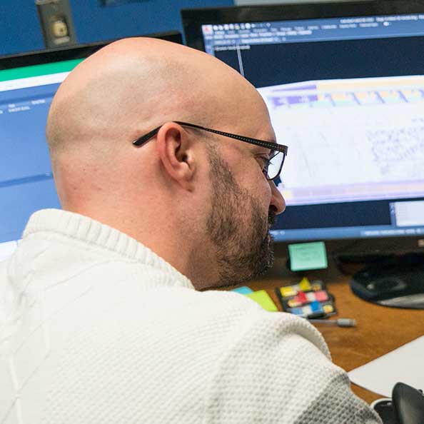 man looking at spreadsheets