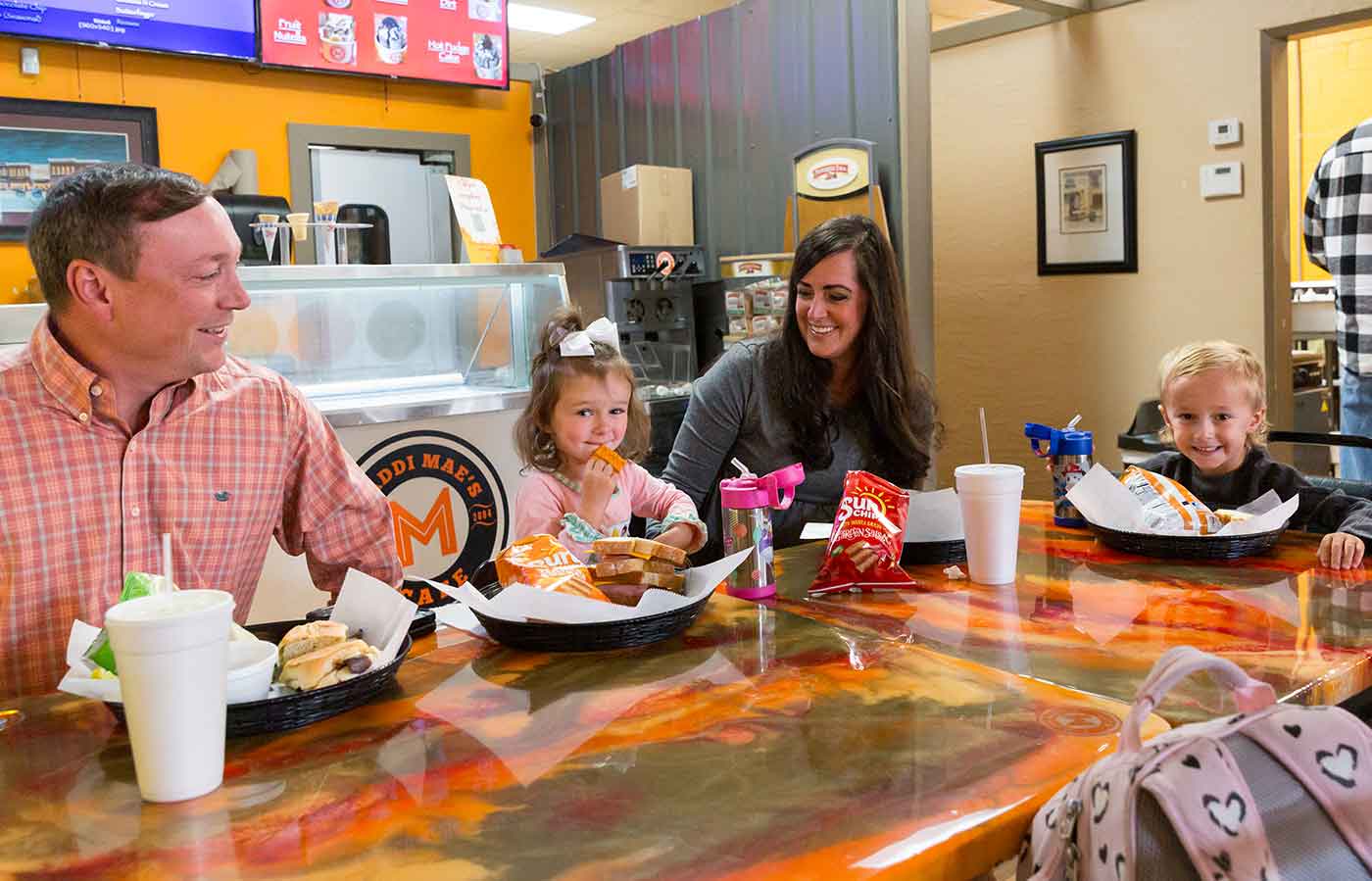 family enjoying a meal at an ice cream parlor