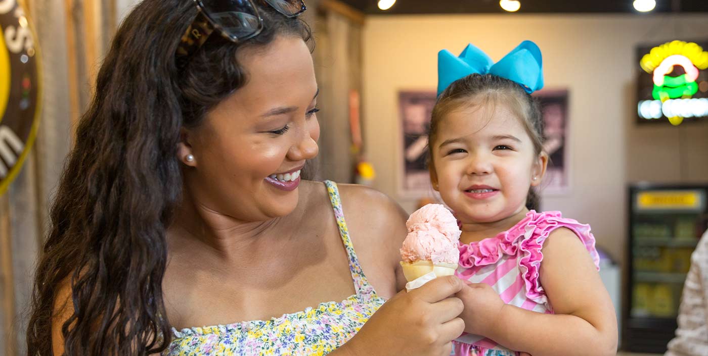 smiling mom and daughter with ice cream cone