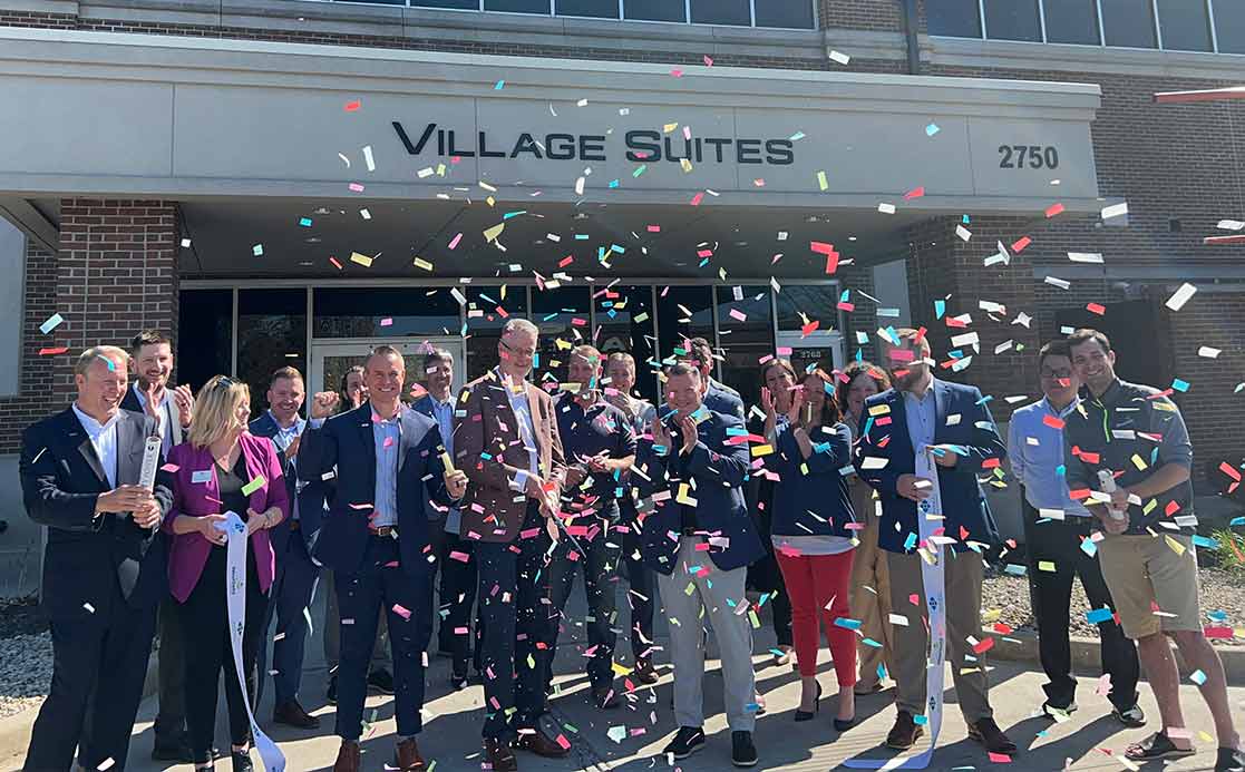 ribbon cutting ceremony at village suites