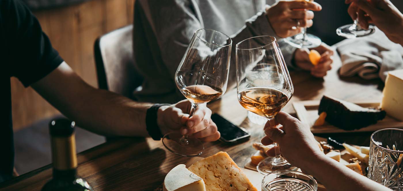 friends toasting wine glasses around a table