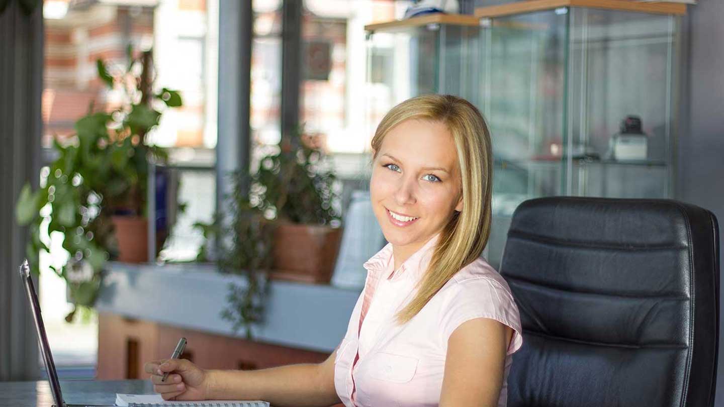 Professional woman seated with her laptop