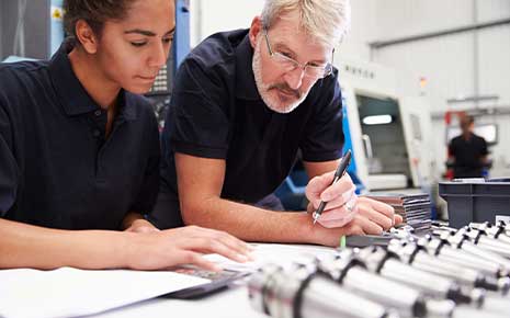 Engineer And Apprentice Planning CNC Machinery Project