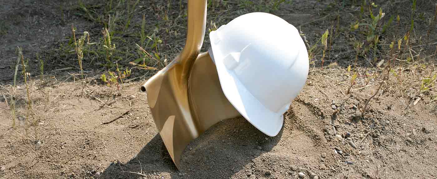 ground breaking ceremony with golden shovel and white hard hat
